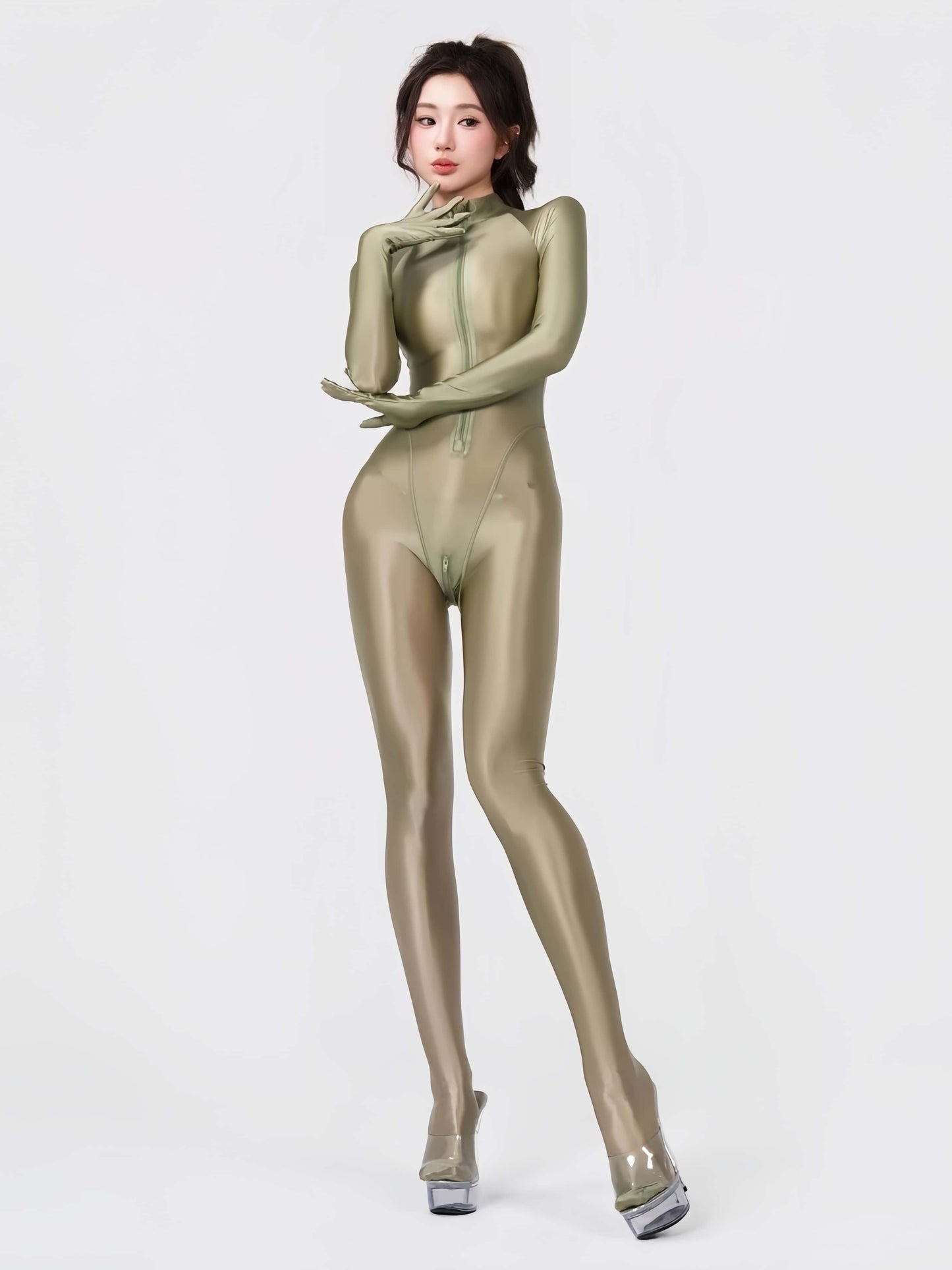 Person wearing a shiny green bodysuit on a white background