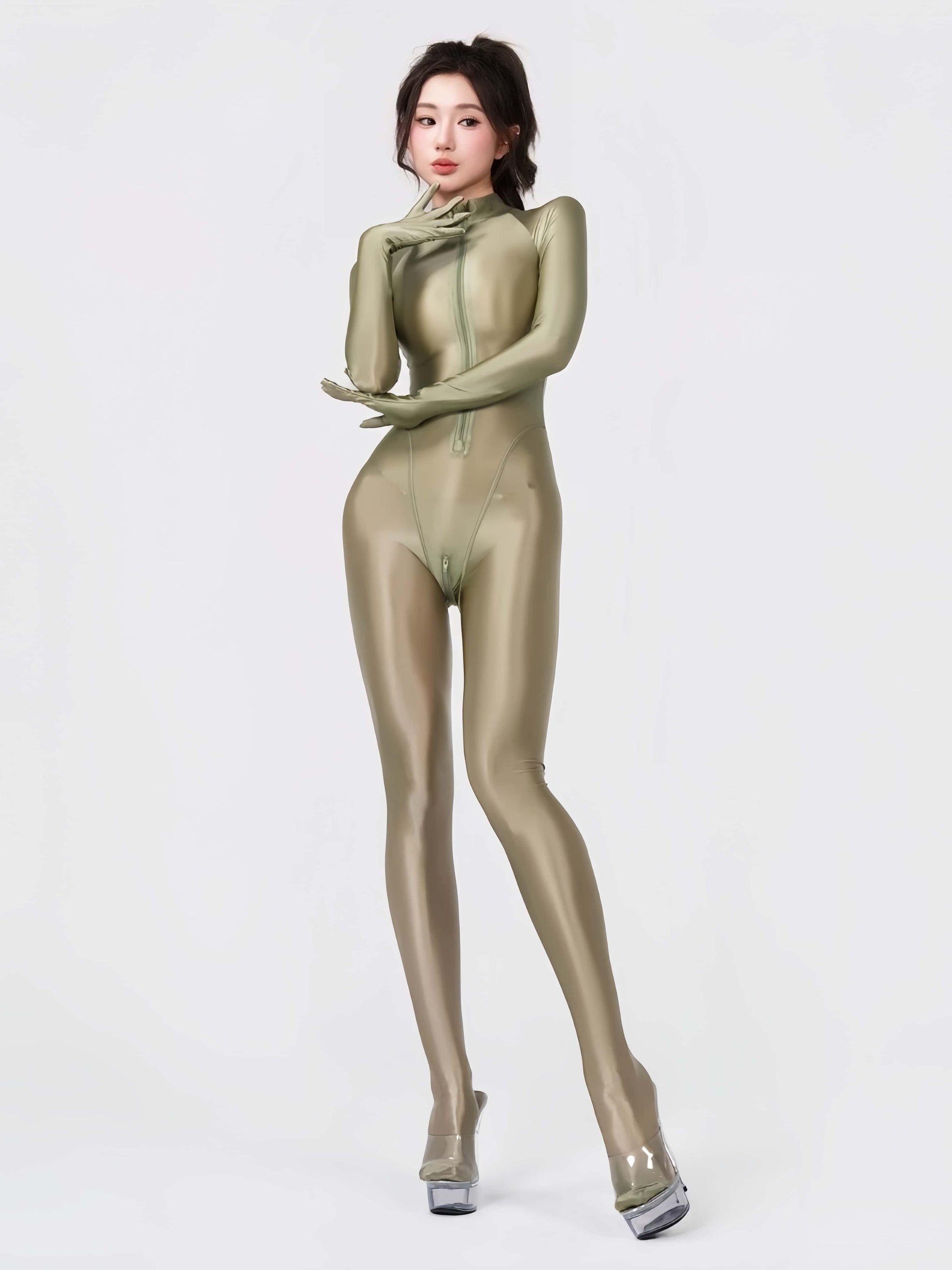 Person wearing a shiny green bodysuit on a white background