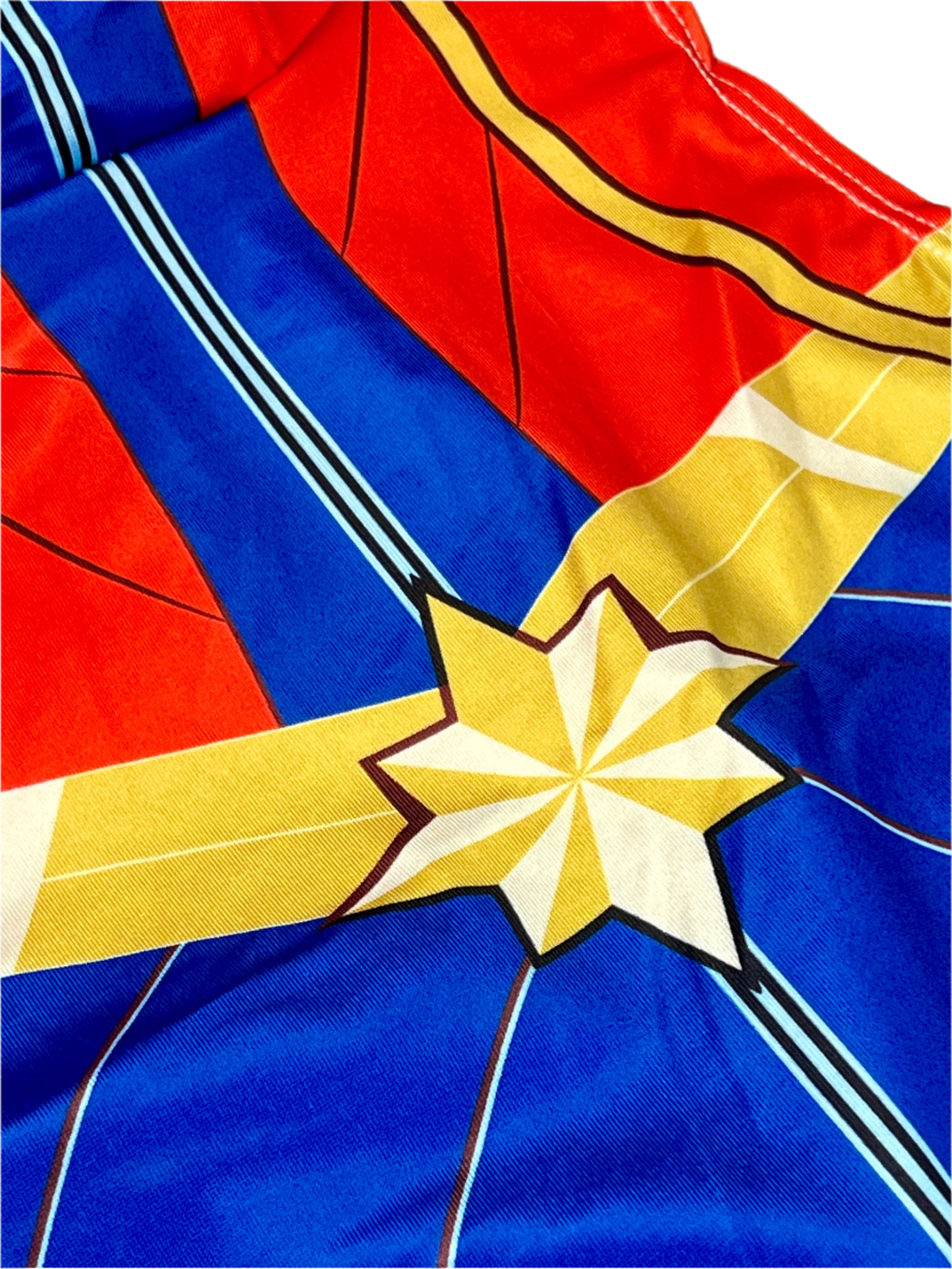 Close-up of a superhero costume with red, blue, and yellow colors.