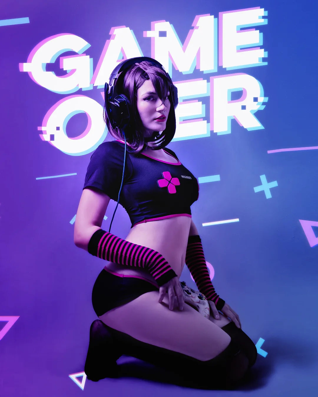 Person wearing headphones with 'GAME OVER' text and graphics in the background