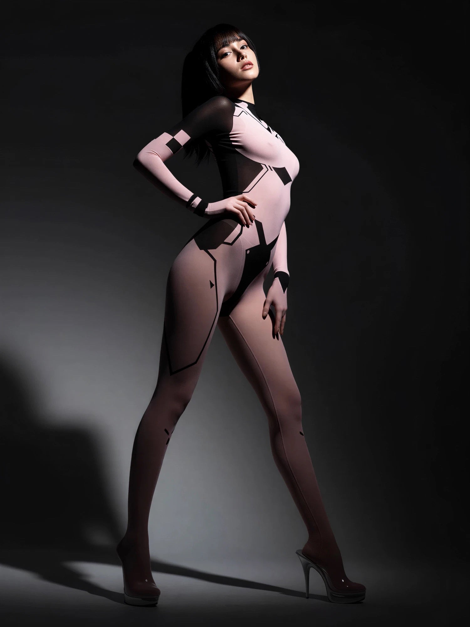 Person wearing a black bodysuit with high heels on a dark background