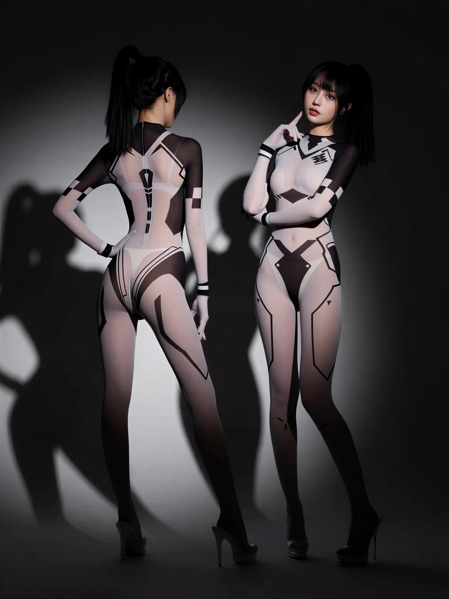Two women wearing futuristic bodysuits against a dark background