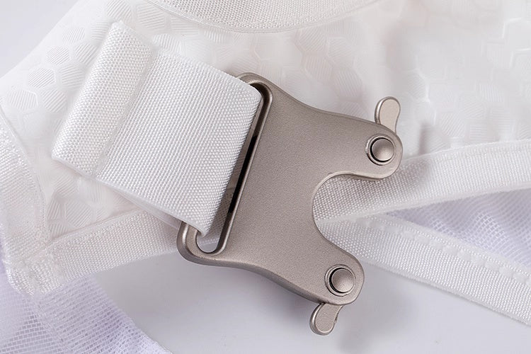 Close-up of a metal buckle on white fabric