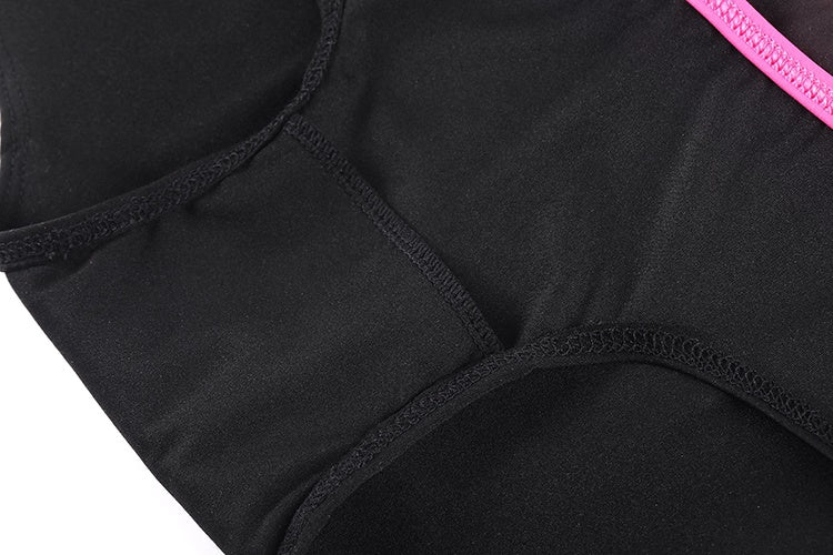 Close-up of black underwear with pink waistband on a white background