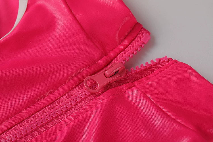 Close-up of a pink jacket with a zipper on a gray background