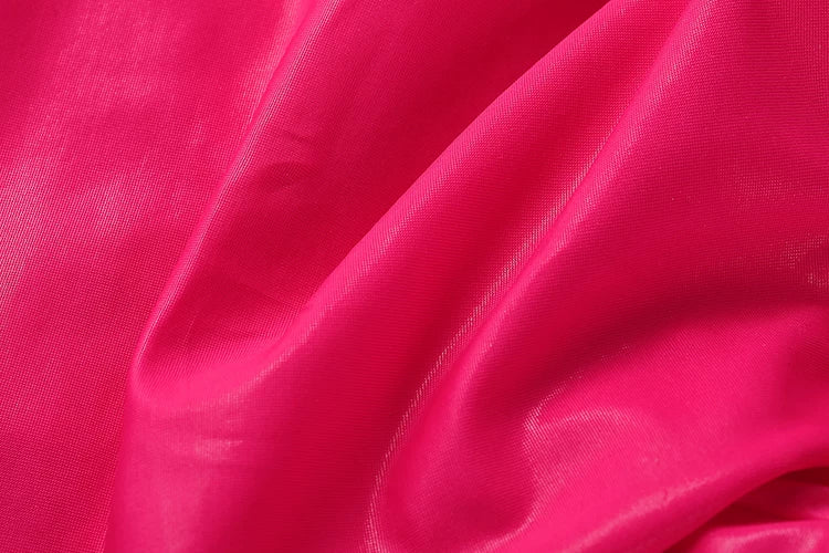 Close-up of bright pink fabric with a satin finish