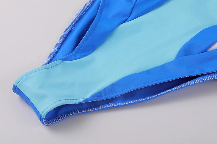 Close-up of blue and light blue gloves on a light gray background