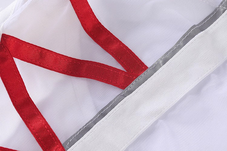 Close-up of a white garment with red trim and gray mesh lining.